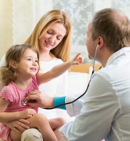 Doctor checking child with stethoscope with mother